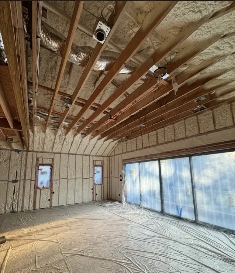 Interior walls and ceiling insulated with spray foam during new construction in Clive